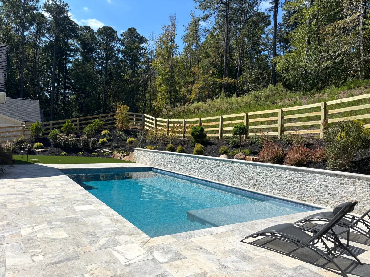 Four-board ranch rail fence with wire along a landscaped pool area in Milton, Georgia